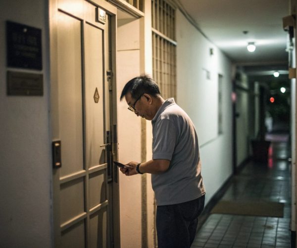 low-quality-photo-of-singaporean-man-open-his-cond